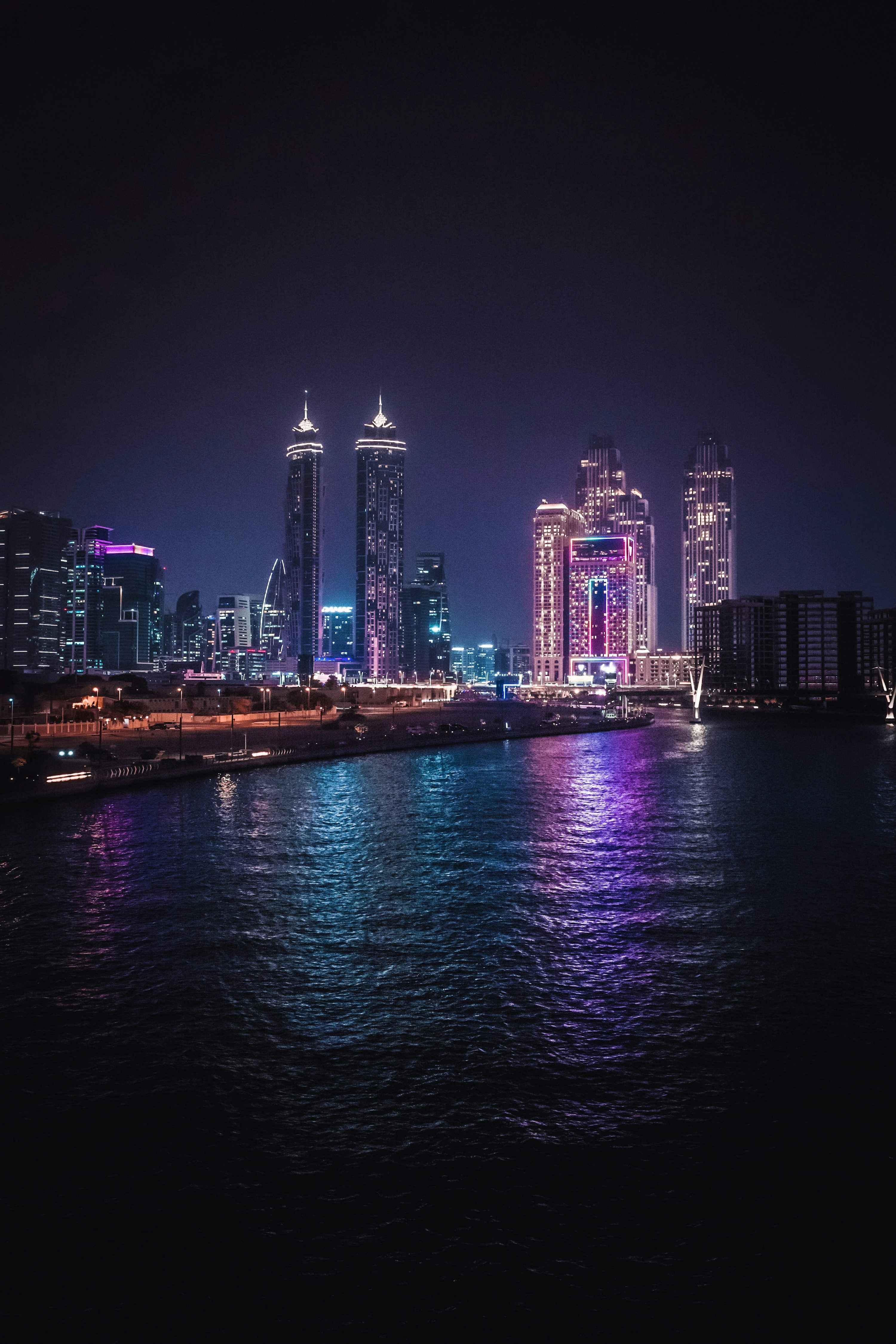 A city skyline is lit up at night