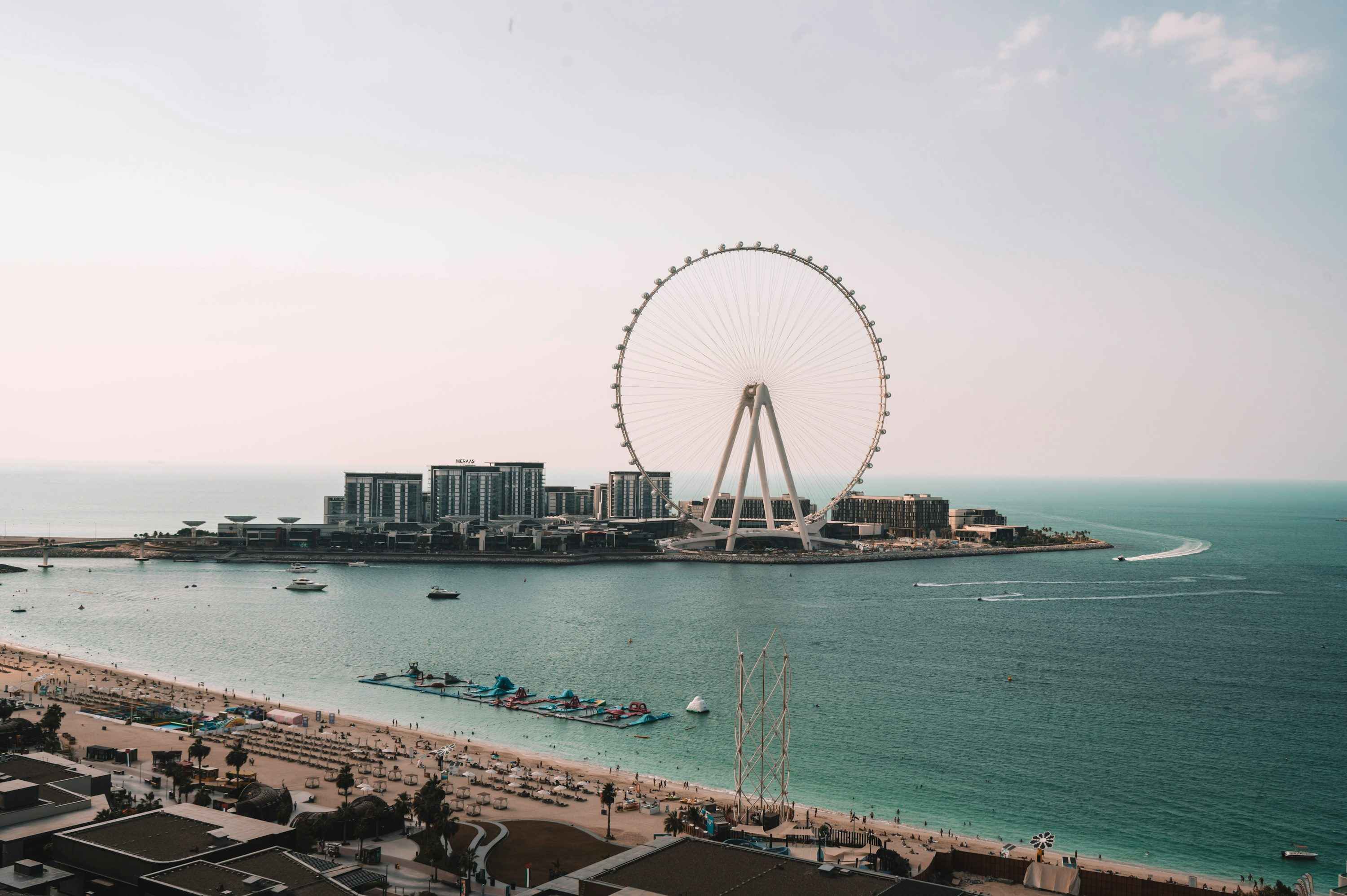 A large ferris wheel sitting on top of a beach