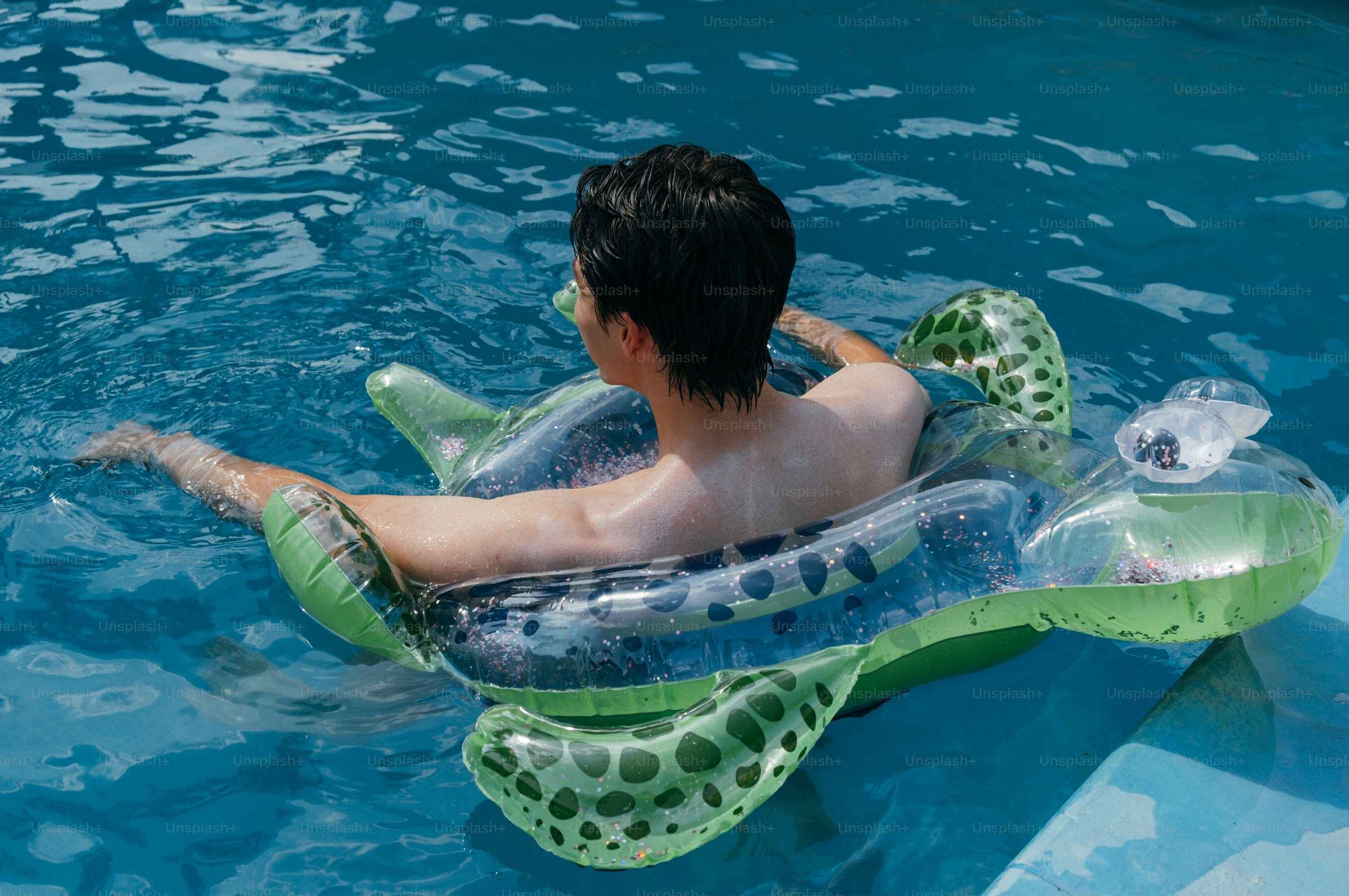 A person enjoys a swim in a pool